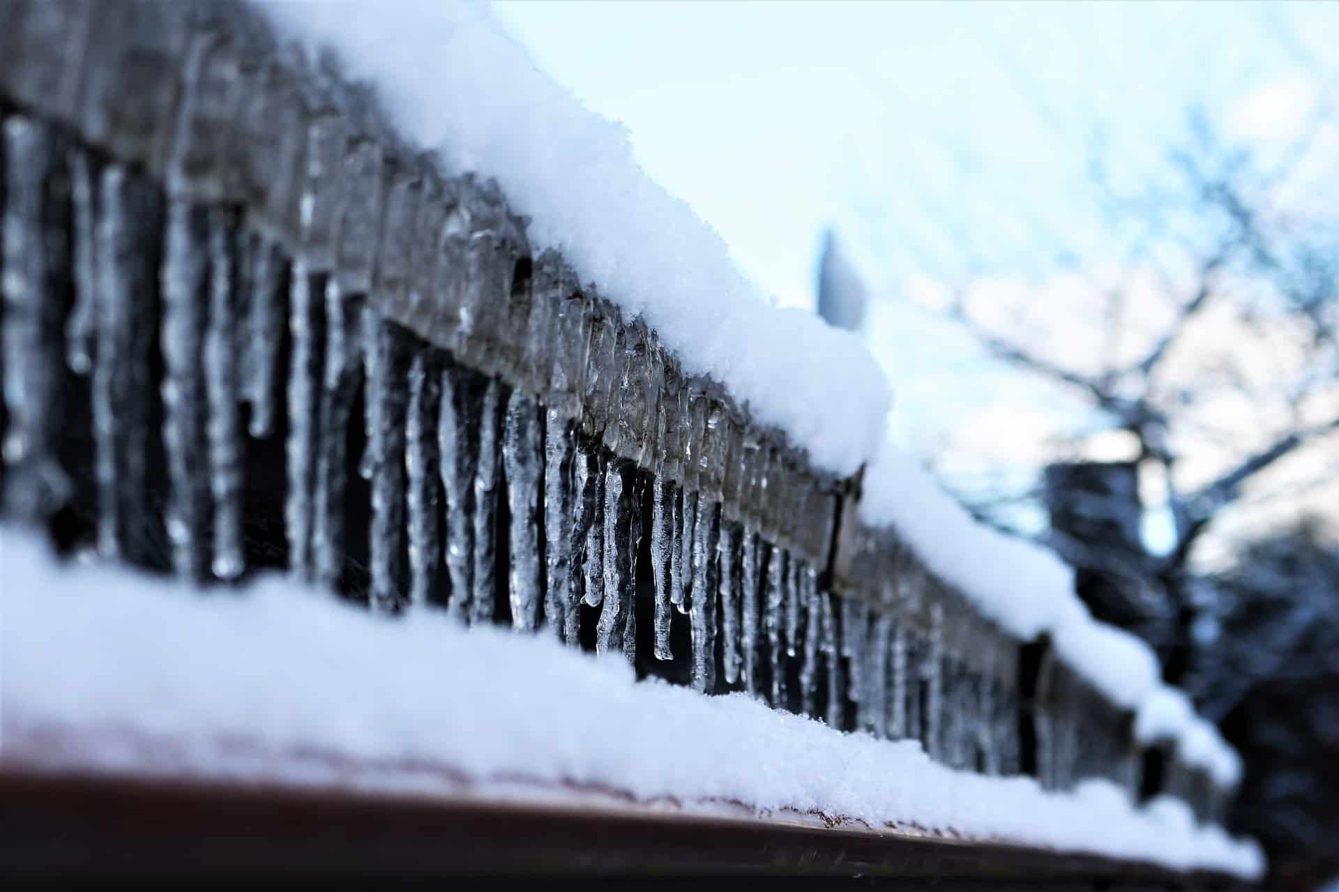 winter gutters with ice and snow